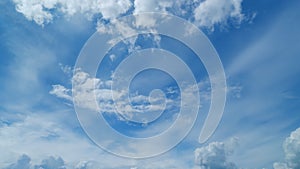 Beautiful cirrus and cumulus cloud formations in a deep blue sky. Soft cirrus couds on blue sky. Timelapse.