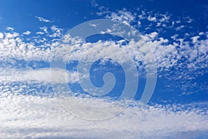 Beautiful cirrus fluffy clouds on a blue sky background