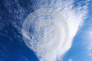 Beautiful cirrus fluffy clouds on a blue sky background