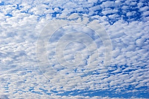 Beautiful cirrus fluffy clouds on a blue sky background