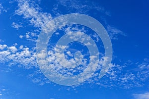 Beautiful cirrus fluffy clouds on a blue sky background