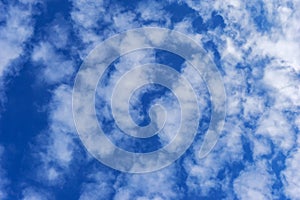 Beautiful cirrus fluffy clouds on a blue sky background