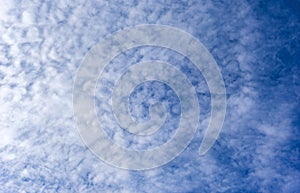 Beautiful cirrus fluffy clouds on a blue sky background