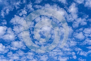 Beautiful cirrus fluffy clouds on a blue sky background