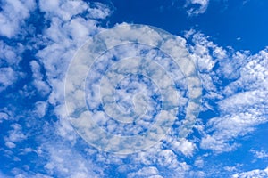 Beautiful cirrus fluffy clouds on a blue sky background