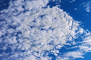 Beautiful cirrus fluffy clouds on a blue sky background