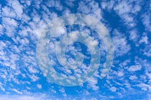 Beautiful cirrus fluffy clouds on a blue sky background