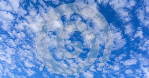 Beautiful cirrus fluffy clouds on a blue sky background