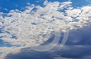 Beautiful cirrus fluffy clouds on a blue sky background