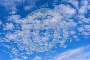 Beautiful cirrus fluffy clouds on a blue sky background