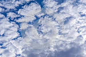 Beautiful cirrus fluffy clouds on a blue sky background