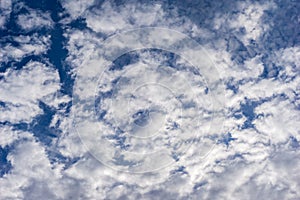 Beautiful cirrus fluffy clouds on a blue sky background