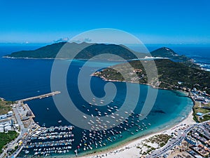 Beautiful city Arraial do Cabo Brazil. Praia dos Anjos. Aerial drone photo from above. Mountains ocean and fishing boats