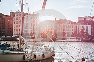 A beautiful city landscape, a port with boats in the rays of the