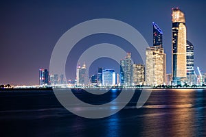 Beautiful City night view of Abu Dhabi financial and commercial district, taken during blue hour, view from marina backwater,