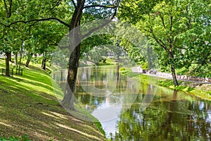 Beautiful city park with river in summer day