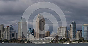 Beautiful city scape with water bay and clouds moving across the dark sky and above the modern architecture buildings