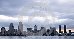 Beautiful city scape with water bay and clouds moving across the dark sky and above the modern architecture buildings