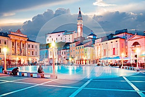 Beautiful city scenery in the central square with the old clock tower in Piran, the tourist center of Slovenia. popular tourist