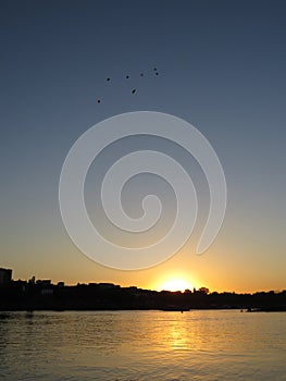Beautiful City Skyline with Flying Balloons on Sky Seen During Sunset over Vistula River, Warsaw, Poland