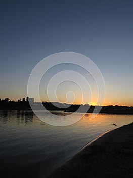 Beautiful City Skyline Seen from Sandy Beach During Sunset over Vistula River in Warsaw, Poland