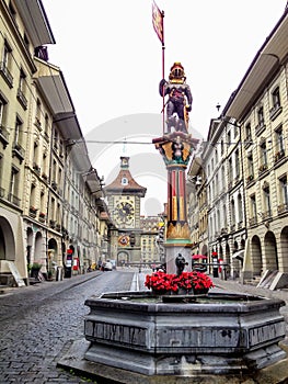 Beautiful City Street View of the colorful medieval Zahringen statue on top of elaborate fountain in Bern, Switzerland.