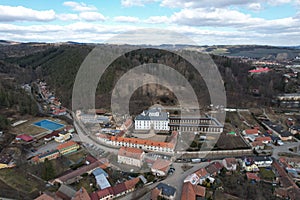 Beautiful cityscape of Cerna Hora with traditional buildings and evergreen hills in Czechia