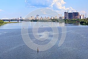 A beautiful cityscape of the Dnipro River in the city of Kyiv on the horizon