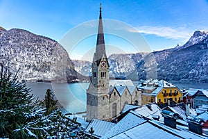 beautiful cityscape of the special city Hallstatt in Austria Salzkammergut snowy winter mountains and lake and church