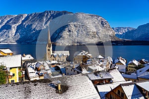 beautiful cityscape of the special city Hallstatt in Austria Salzkammergut snowy winter mountains and lake and church