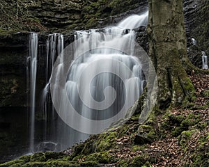 Beautiful claming landscape image of Scaleber Force waterfall in Yorkshire Dales in England during Winter morning