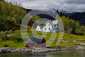 Beautiful, classic white farmhouse next to fjord in Norway