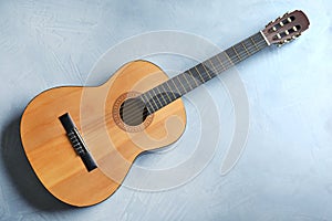 Beautiful classical guitar on color background