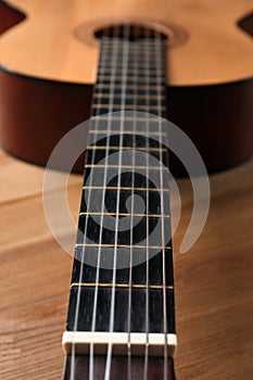 Beautiful classical guitar on wooden background