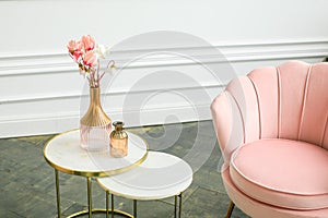 Beautiful classical white interior with a sofa and a coffee table. Retro, classics. Luxury white interior