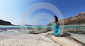 Beautiful classy woman on a beach with turquoise clear waters