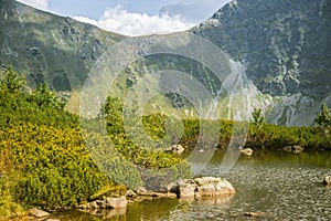 A beautiful, clean lake in the mountain valley in calm, sunny day. Mountain landscape with water in summer.