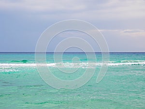 Beautiful clear cyan sea water near Nissi beach on a cloudy murky day in Ayia Napa, Cyprus