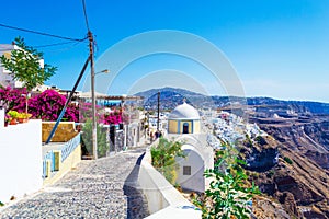 Beautiful cliff top narrow cobblestone old street in Firostefani Santorini Greece