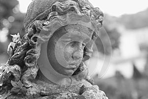 Beautiful close up af a face angel stone sculpture with a sweet