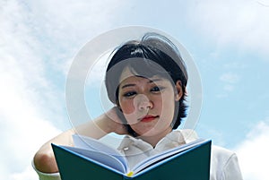 Beautiful close up Asia woman holding and reading book.