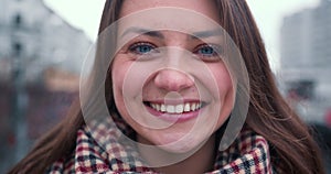 Beautiful close-up face of excited happy beautiful 25-30 Caucasian brunette woman smiling, posing at camera slow motion.