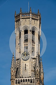 Beautiful close-up on the head of the Belfry of Bruges during a sunny day