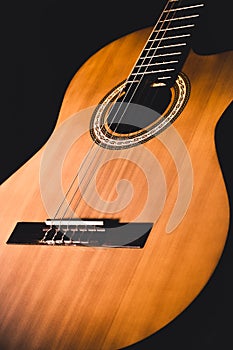Beautiful close up illustration of wooden classical guitar with front view on dark background
