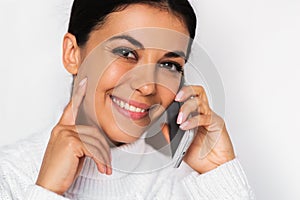 Beautiful close up portrait of attractive young happy woman with mobile phone with pretty toothy smile, on the white background.