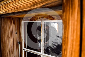 Beautiful close-up view of an old, weathered wooden window with a big window frame seen at a mountain cabin in the Swiss Alps, Swi