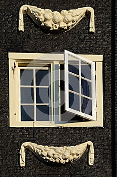 Beautiful close-up window with stucco facade in Amsterdam