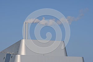 Beautiful closeup bright view of Covanta Plant Dublin Waste to Energy against clear blue sky seen from Sandymount Beach, Dublin