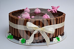 Beautiful closeup of a chocolate cake with a design of pigsty with swines