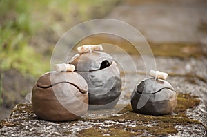 Beautiful closeup of unique handmade three pots in summer